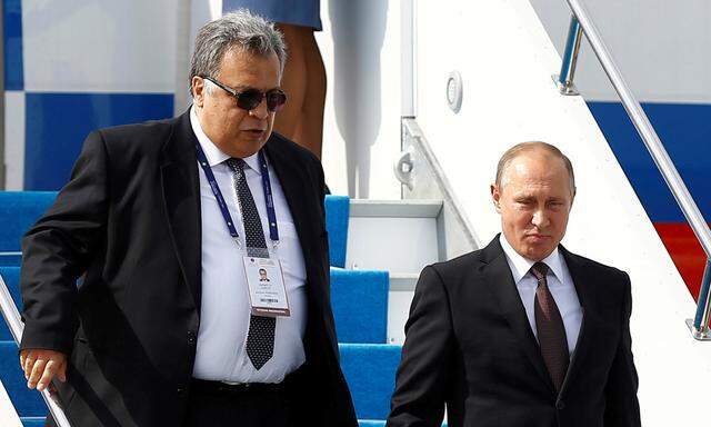 FILE PHOTO - Russian President Vladimir Putin next to Russian Ambassador to Turkey Andrei Karlov disembarks from the Presidential aircraft at Ataturk airport in Istanbul