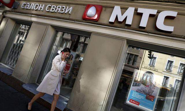 Woman passes by an office of mobile phone operator MTS, in which Sistema has an effective ownership stake, in St. Petersburg