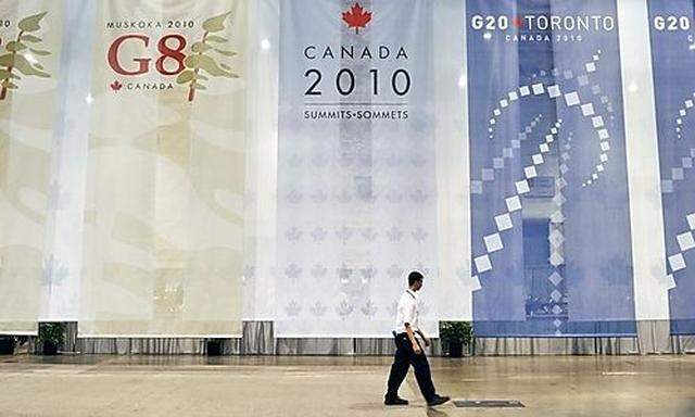 A member of the media walks past the welcome entrance to the International Media Centre which will ho