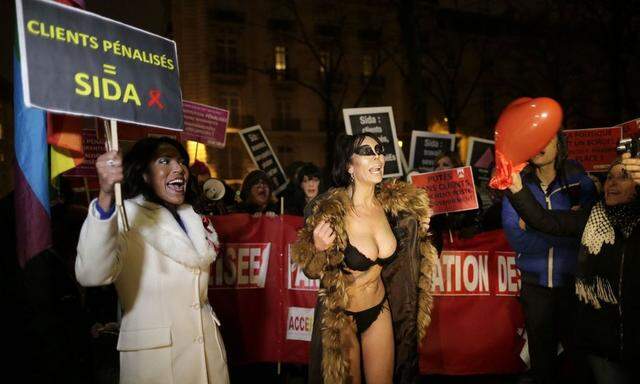 Sex workers attend a protest demonstration after French deputies voted for a reform of prostitution law in Paris