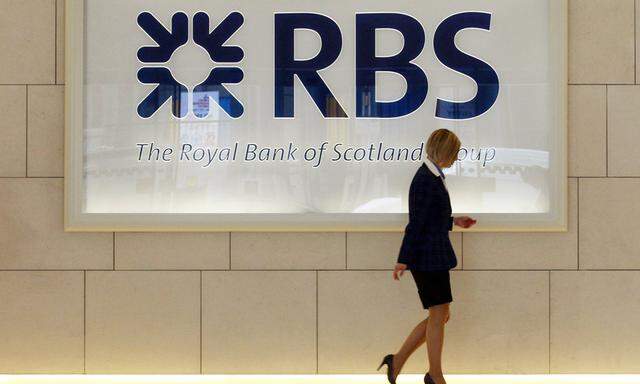 File photo of a worker walking in the foyer of a Royal Bank of Scotland office in the City of London
