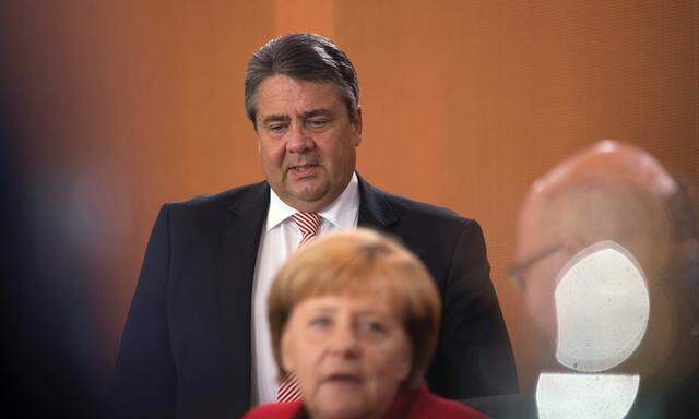German Chancellor Angela Merkel and Economy Minister Sigmar Gabriel attend a cabinet meeting at the Chancellery in Berlin