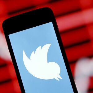 FILE PHOTO: Photo illustration of Twitter logo in front of stock graph