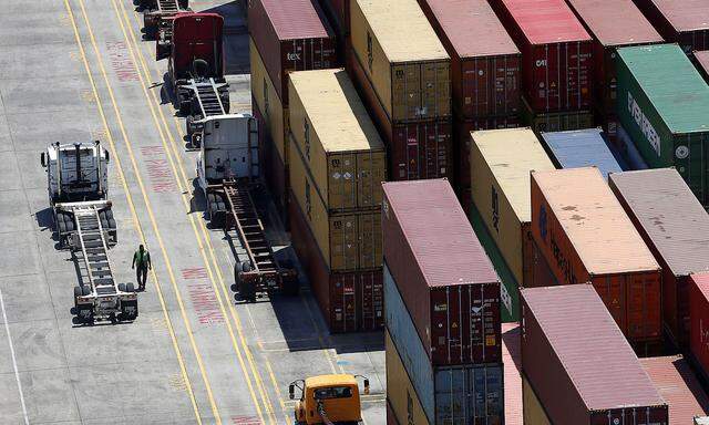 FILE PHOTO: Workers stack empty shipping containers for storage at Wando Welch Terminal operated by the South Carolina Ports Authority in Mount Pleasant