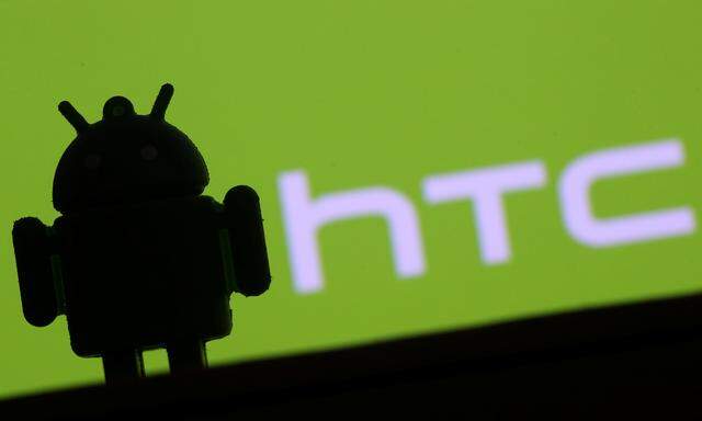 A 3D printed Android mascot Bugdroid is seen in front of an HTC logo in this illustration