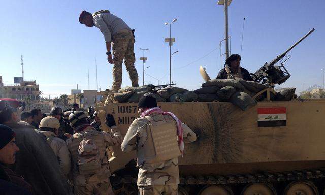 Iraqi soldiers take positions during an intensive security deployment on the outskirts of Anbar province