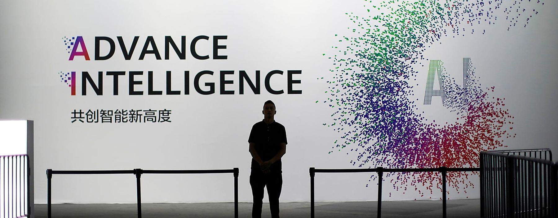 A security officer keeps watch in front of an AI (Artificial Intelligence) sign at the annual Huawei Connect event in Shanghai