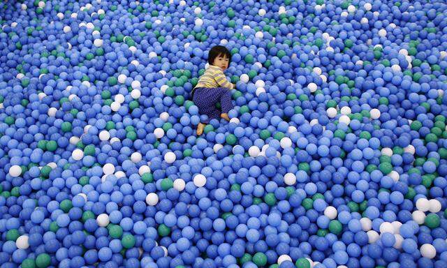Two-year-old Nao Watanabe plays in a ball pit at an indoor playground which was built for children and parents who refrain from playing outside because of concerns about nuclear radiation in Koriyama