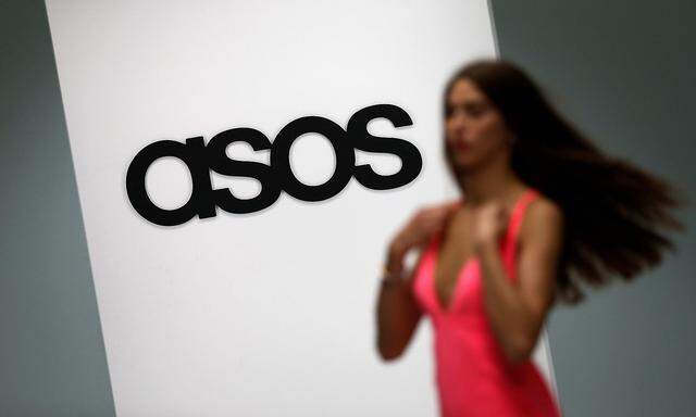 FILE PHOTO: A model walks on an in-house catwalk at the ASOS headquarters in London