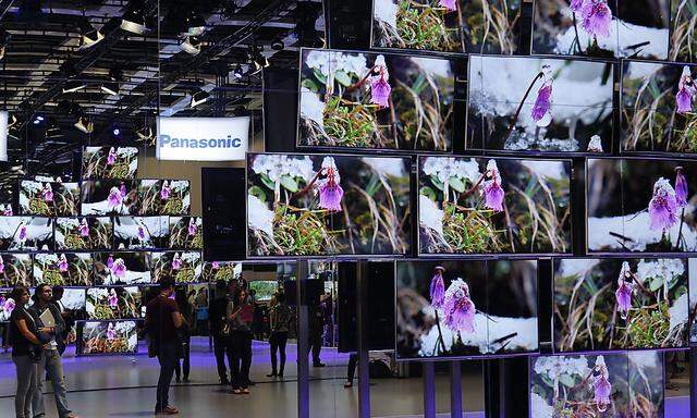 People watch 4K TV screens during a media preview at the Panasonic booth  at the IFA consumer electronics fair in Berlin