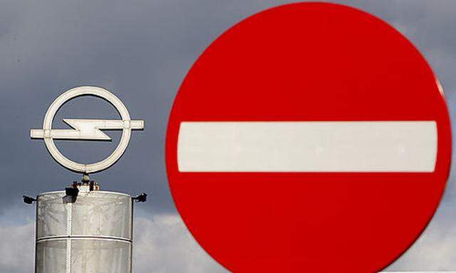 An Opel logo is seen next to a traffic sign outside an Opel dealer in Antwerp, Belgium, Thursday Sept