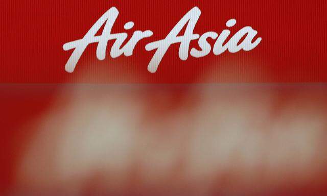 An AirAsia logo is pictured at the ticketing counter at Changi Airport in Singapore