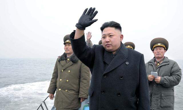 North Korean leader Kim Jong-Un  waves from a boat in the southwest of Pyongyang