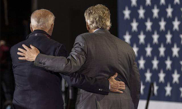 President Joe Biden speaks with Terry McAuliffe, Democratic candidate for governor of Virginia, at a rally in Arlington