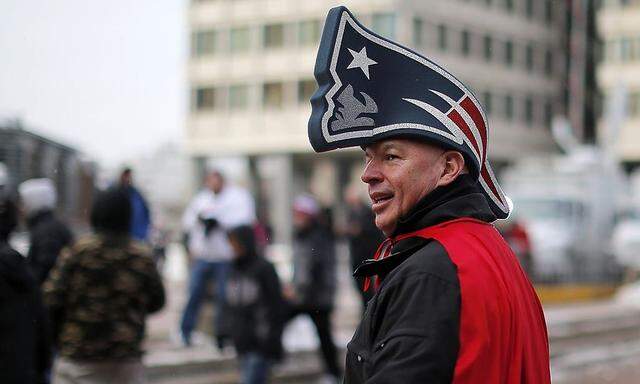 A New England Patriots fan arrives for a send off rally for the team outside City Hall in Boston