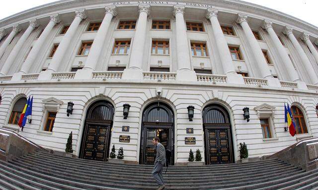A man walks in front of Romania´s Central Bank headquarters during a news conference of the International Monetary Fund (IMF)´s Romania mission in Bucharest