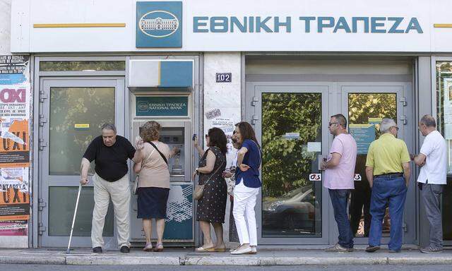 Referendum campaign posters that reads ´No´ in Greek are seen as people line up at an ATM outside a National Bank branch during a referendum vote in Athens