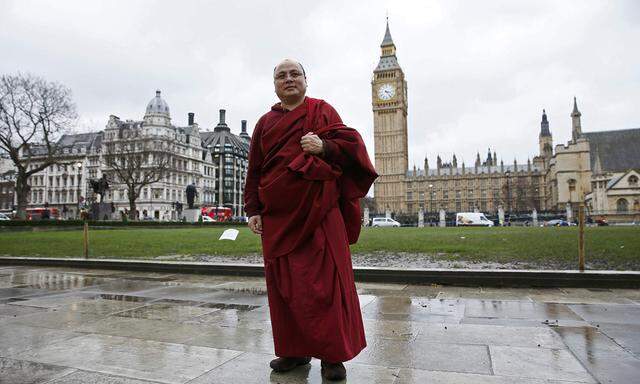 Former political prisoner Tibetan monk Golog Jigme poses for a photograph outside the Houses of Parliament in London
