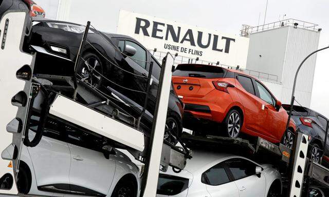 FILE PHOTO: New Renault and Nissan automobiles are loaded onto a transporter at the Renault SA car factory in Flins