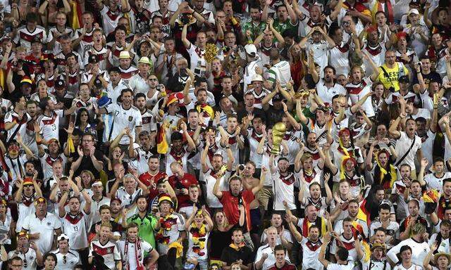Germany's fans celebrate after their team scored a goal during their 2014 World Cup final against Argentina at the Maracana stadium in Rio de Janeiro