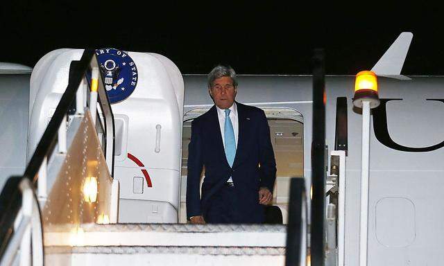 U.S. Secretary of State John Kerry disembarks from his aircraft after arriving at Kabul International Airport
