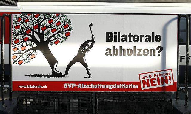 A poster against the ´mass immigration initiative´ of the Swiss People´s Party is seen at the main train station in Zurich
