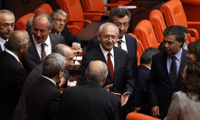 Turkey's main opposition Republican's People Party (CHP) leader Kemal Kilicdaroglu chats with his party MPs as Turkish Parliament convene in Ankara