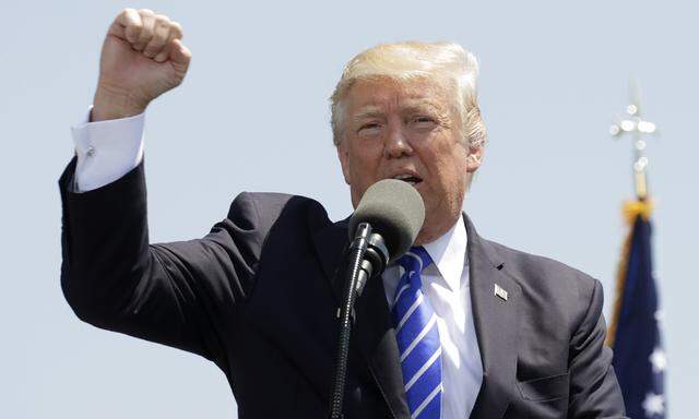 U.S. President Donald Trump pumps his fist as he delivers commencement address at U.S. Coast Guard Academy in New London