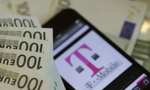 A photo illustration shows the company logo of mobile phone provider T mobile and some bank notes in Vienna