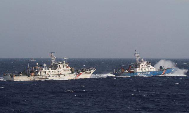 FILE PHOTO: A ship of Vietnam Marine Guard is seen near a ship of Chinese Coast Guard in the South China Sea