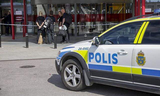 Police officers are seen in front of an Ikea store in Vasteras