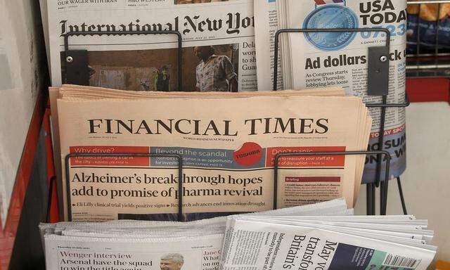 Copies of the Financial Times newspaper sit in a rack at a newsstand in London