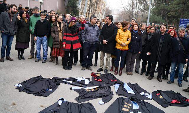 Academics lay down their gowns during a protest against the dismissal of academics from universities following a post-coup emergency decree, in the Cebeci campus of Ankara University in Ankara