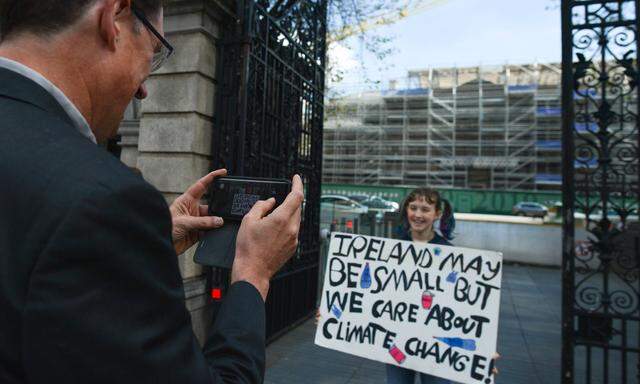 May 10 2019 Dublin Ireland Eamon Ryan the Green Party leader takes a photo of a young activ