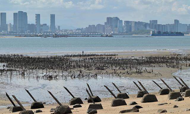 Die Skyline der chinesischen Stadt Xiamen im Hintergrund, im Vordergrund Landminen, die entlang der Küste der Insel Lieyu auf Taiwans Kinmen-Inseln gelegt wurden.