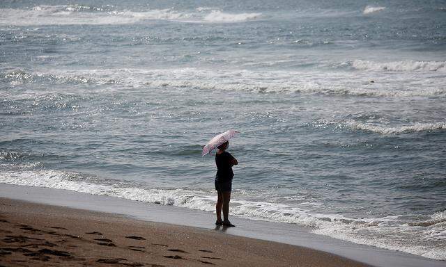 A woman wearing a mask enjoys a late summer day amid the coronavirus disease (COVID-19) outbreak on Jeju island