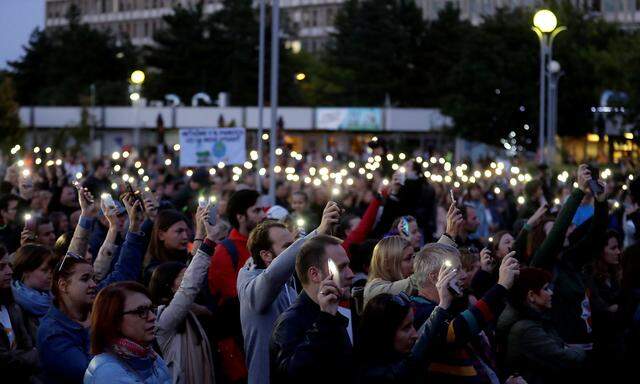 FILE PHOTO: Demonstrators light up their mobile phones as they  attend an anti-government protest rally in reaction to last year's killing of the investigative reporter Jan Kuciak and his fiancee Martina Kusnirova in Bratislava