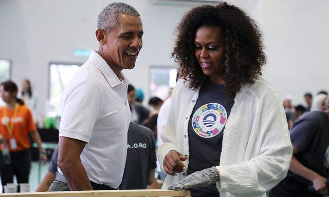 Former U.S. President Barack Obama and former first lady Michelle Obama attend a community service project in Petaling Jaya