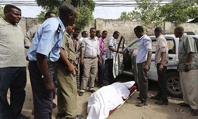 The body of Somali member of parliament Warsame lies next to a vehicle in Mogadishu