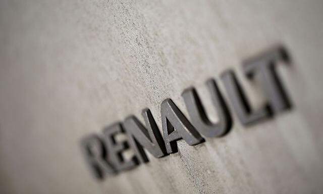 Mud and dust cover the logo of a van manufactured by the Renault automobile company which is parked in a street in Paris