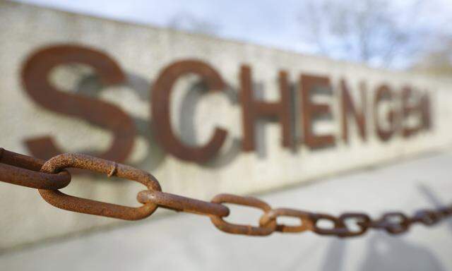 A rusty chain hangs in front of the quay of the small Luxembourg village of Schengen at the banks of the river Moselle