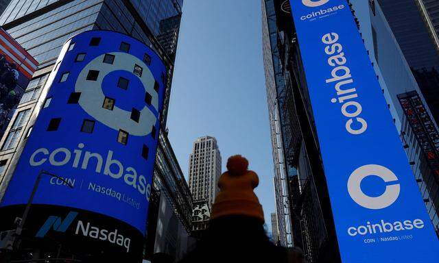 FILE PHOTO: The logo for Coinbase Global Inc is displayed on the Nasdaq MarketSite jumbotron and others at Times Square in New York