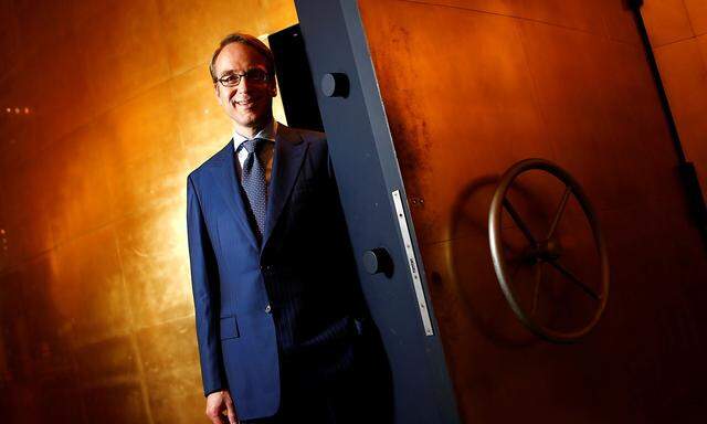 FILE PHOTO: Germany's federal reserve Bundesbank President Weidmann stands beside the door of a giant safe as he poses for a photograph at the money museum next to the Bundesbank headquarters in Frankfurt