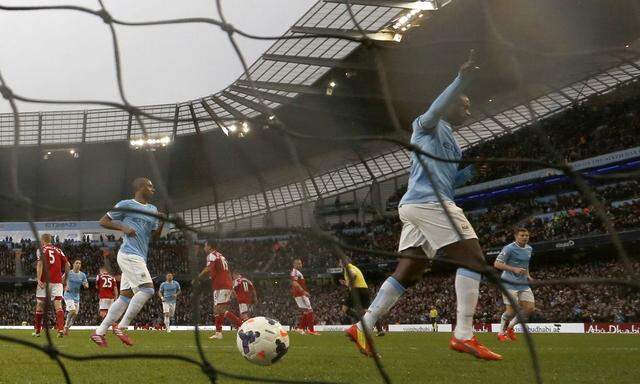 Manchester City's Toure celebrates after scoring a penalty against Fulham during their English Premier League soccer match at the Etihad stadium in Manchester