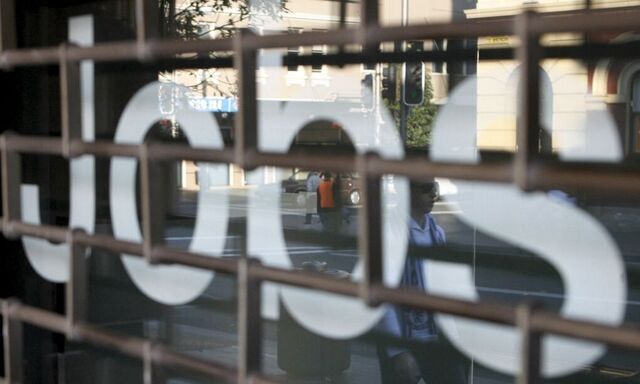 File photo of pedestrians walking past a jobs office in Sydney