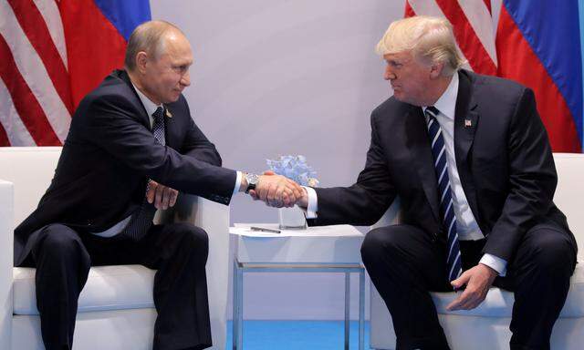 FILE PHOTO - U.S. President Donald Trump shakes hands with Russia's President Vladimir Putin during the their bilateral meeting at the G20 summit in Hamburg