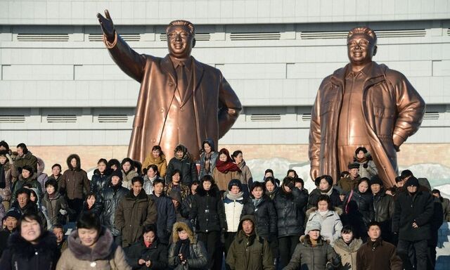 North Korean people visit in front of bronze statues of North Korea founder Kim Il-sung and late leader Kim Jong-il at Mansudae in Pyongyang
