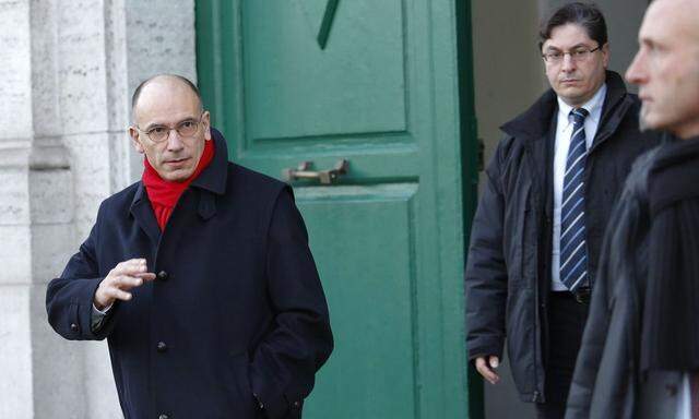 Italy's Prime Minister Enrico Letta gestures as he leaves his house in downtown Rome