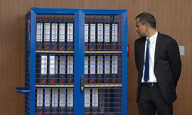 File photo of Edathy standing next to a locker with investigation documents in Berlin