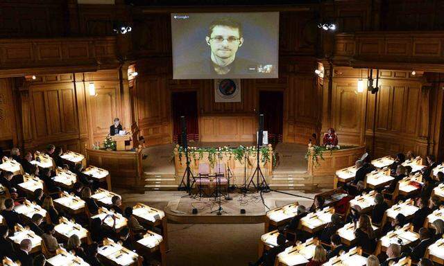 Swedish MP Westerholm speaks to Edward Snowden during the Right Livelihood Award ceremony at Swedish Parliament in Stockholm